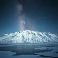 A snow-covered mountain range under a clear, starry night sky, with the Milky Way visible in the background and a frozen lake reflecting the celestial beauty.
