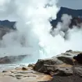 A bubbling geyser erupting in a dramatic display of steam and water, set against a backdrop of a rugged, volcanic landscape.